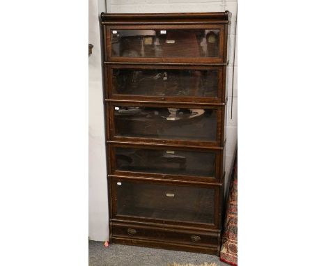 A Globe Wernicke five-tier oak stacking bookcase, bearing label, 87cm by 31cm by 174cmCondition report: The top handle is mis