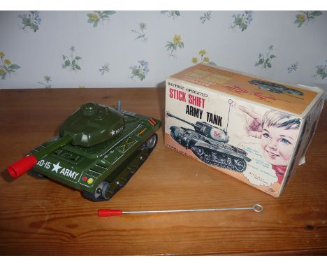 A vintage Japanese stick shift army tank in box. Metal and plastic. 