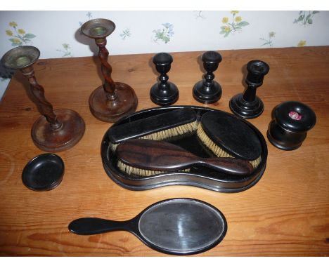 A 9 piece ebony dressing table set and a pair of barley twist candle stick holders. 