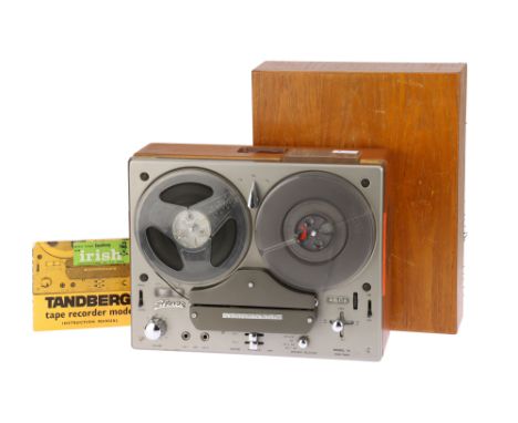 A Tandberg Model 74 Reel to Reel Player &amp; Recorder, body G-VG, unit powers on, speakers crackle with movement of the volu