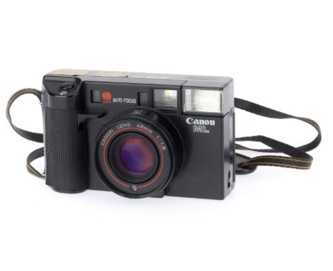 A Canon ML 35mm Auto Focus Camera, black, body G, has two labels stuck to top, powers up, takes a pictire, advances and flash