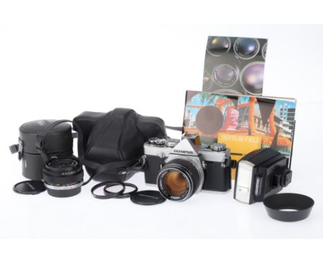An Olympus OM-1 Camera Outfit, comprising the OM-1, silver, serial number 921240, body G, shutter works, viewfinder display w