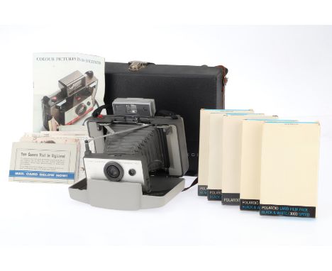 A Polaroid 103 Land Camera and Case, comprising the camera, grey, extends and closes correclty, shutter works, with 5 packs o