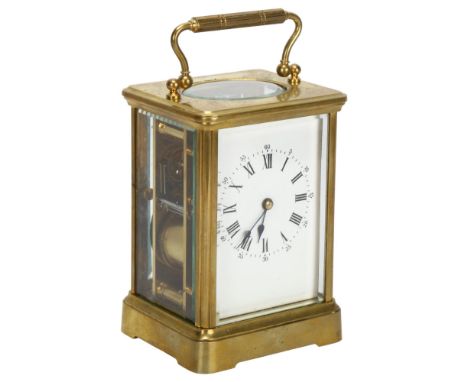 A 19th century brass-cased carriage clock, white enamel dial with Roman numeral hour markers and movement striking on a gong,