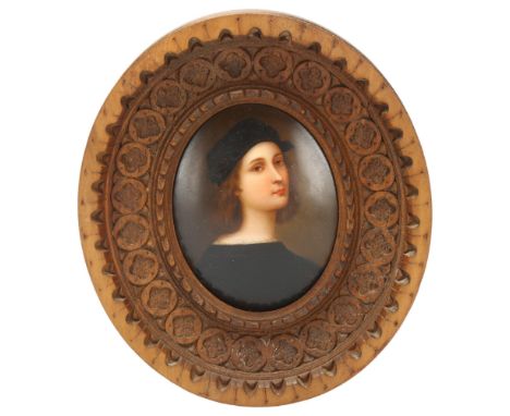 A 20th century miniature portrait on porcelain plaque, after Raphael's self-portrait, in carved wood frame length 9cmPlaque i