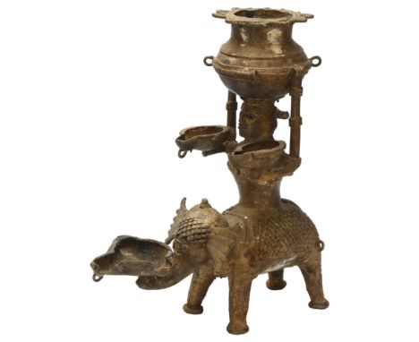 An early 19th century Basar tribal oil lamp depicting Lakshmi, Goddess of Light on a elephant carrying an oil pitcher or Kala