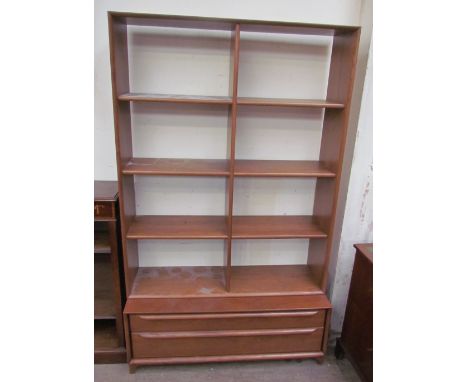 A modern teak bookcase, with eight shelf sections, the base with two long drawers bracket feet