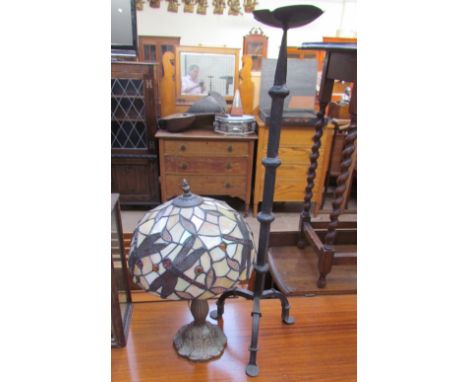 A Tiffany style table lamp, the shade decorated with dragonflies together with a cast iron candlestick