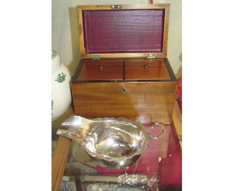 An Irish silver sauce boat together with a 19th century mahogany tea caddy