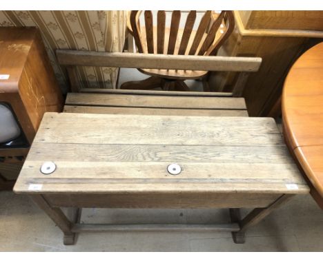 A pine double school desk with ceramic ink inserts