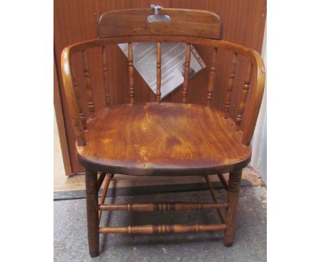 A 19th century stick back captain's chair, with a pierced handle to the back