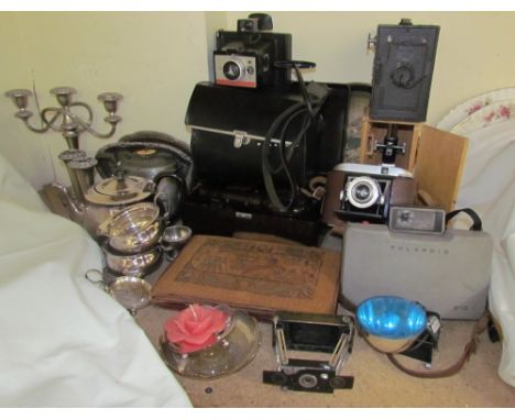 An electroplated three piece tea set together with a candelabra, Polaroid cameras, other cameras, bakelite hair dryer, purse,