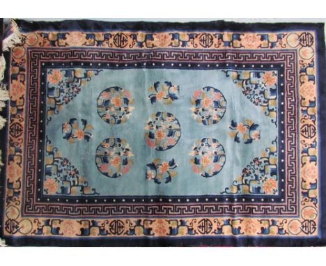 A rug with a light blue ground and circular floral medallions with geometric and floral borders