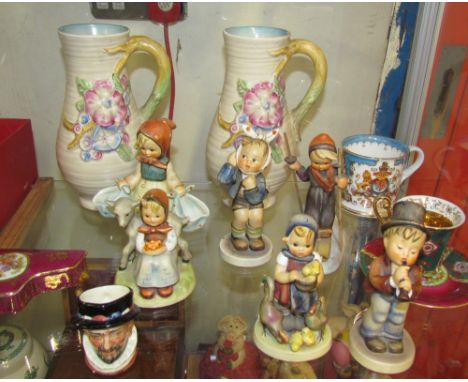 A pair of Clarice Cliff jugs, together with Hummel figures, Royal Doulton mini character jug etc