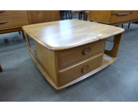 An Ercol Blonde elm Pandora's Box coffee table 