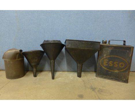 A vintage Esso petrol can, and funnels etc. 