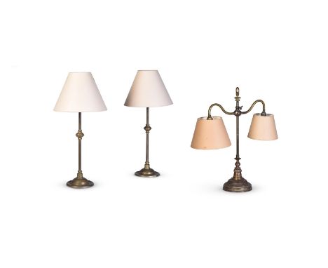 A VICTORIAN BRASS TWIN LIGHT TABLE LAMP  CIRCA 1890 AND LATER  With cream card shades to the lights, adjustable knopped suppo