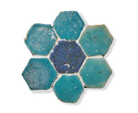 A PANEL OF KASHAN HEXAGONAL TILES  PERSIA, 12TH/13TH CENTURY  The central lustred cobalt tile surrounded by six monochrome tu