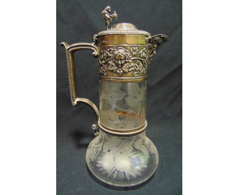 A Victorian hallmarked silver and glass claret jug, the body etched with grapes and vine leaves, the silver collar chased wit