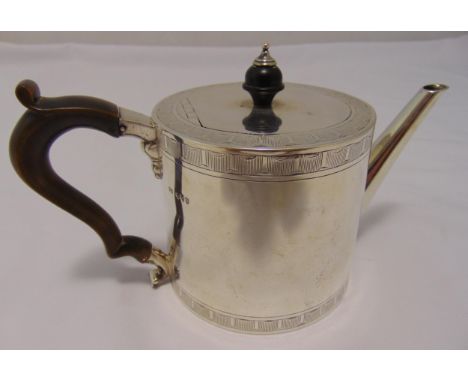 A Victorian hallmarked silver drum teapot, cylindrical with engraved bands the flat hinged cover with turned wooden finial an