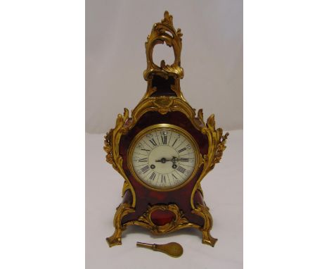 A late 19th century French Rococo style gilt metal and tortoiseshell mantle clock, two train movement white enamel dial with 
