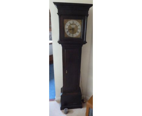 An oak long cased clock with silvered dial and Roman numerals by Josiah Whittman of Chichester, to include pendulum and weigh