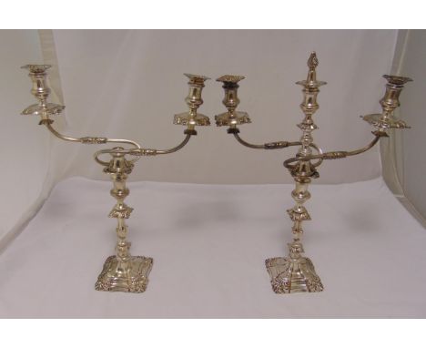 A pair of hallmarked silver three light candelabra, knopped fluted baluster stems on raised square bases chased with shells, 