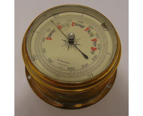 A wall mounted brass barometer, circular with silvered dial, 18cm diameter