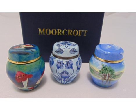 Three Moorcroft miniature enamel boxes and covers decorated with flowers, mushrooms and landscapes, 5cm (h) to include origin