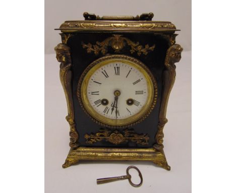 A gilded metal and ebonised mantle clock with white enamel dial and Roman numerals, 22cm (h)