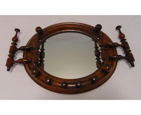 A Victorian mahogany wall mounted spindle mirror of circular form, 31 x 37cm