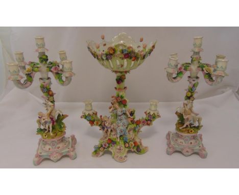 A quantity of 19th century continental porcelain to include a pair of five light candelabra and a table centre piece profusel