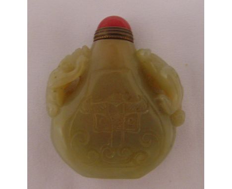 A Celadon jade snuff bottle, pear shaped with carved figures to the sides, 6cm (h)