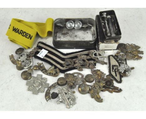 A collection of WWI and other military cap badges, together with a Record Pyrex syringe in original box, British rail button 