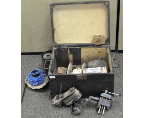 A wooden box containing a selection of tools, including cables