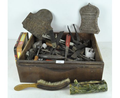 A collection of tools, including planer, metal plaques and more