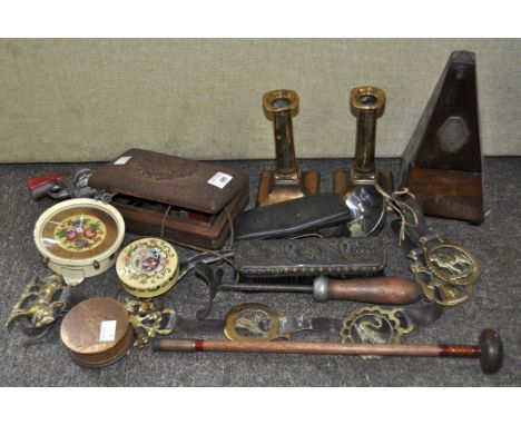 A group of mixed collectables including a metronome, brass candle sticks, cap gun and other items