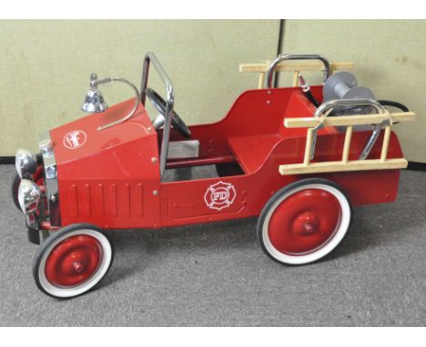 A vintage child's pedal car fire engine by Baghera