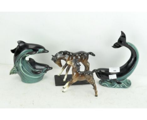 Two Poole pottery figures of dolphins, together with two Beswick horses