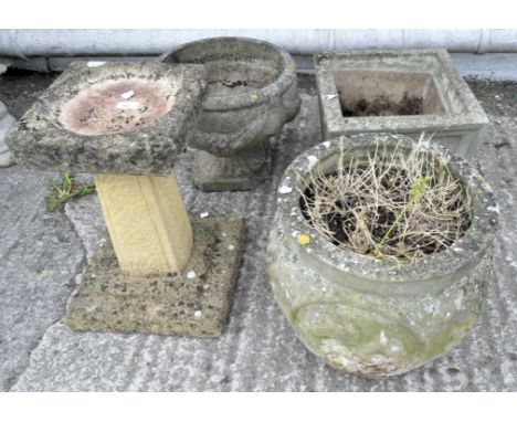 Three reconstituted stone garden planters and a footed bird bath, largest 48cm high