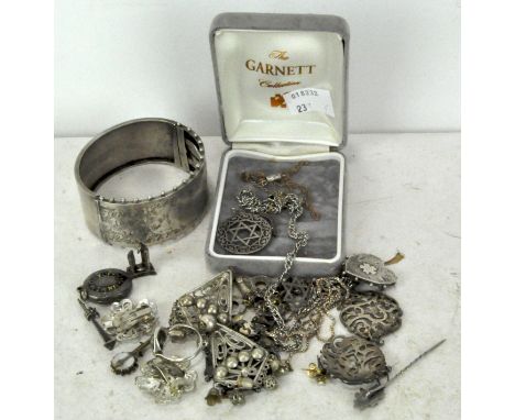 A collection of silver and white metal jewellery, including hinged bangle, pendant, earrings and more, 