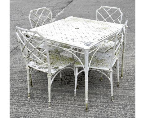 A white painted metal garden table with four chairs, simulated wicker design, chairs 85cm high, table 89cm wide