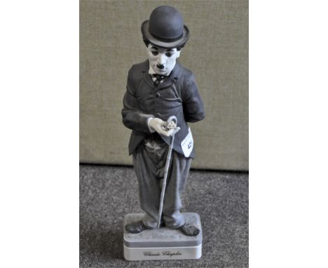 A Spanish ceramic figure depicting Charlie Chaplin, marked to base "personajes del cine Algora" 34cm high