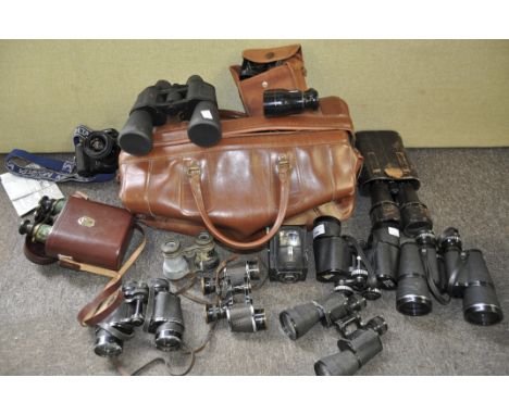 A collection of binoculars and camera equipment, including Minolta and Merveilleuse