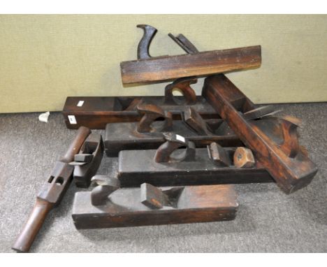 A collection of large wood working planes and other tools