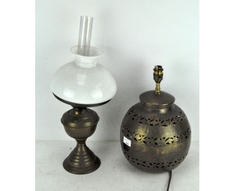 A brass oil lamp, with original white glass shade and chimney, 51cm high; together with a table lamp