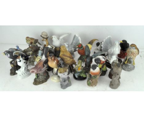 A large collection of ceramic figures of birds, to include a Kestrel