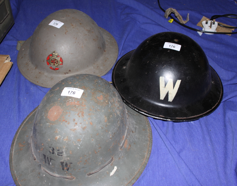 A WWII tin hat belonging to the National Fire Service and two other tin hats belonging to a war w