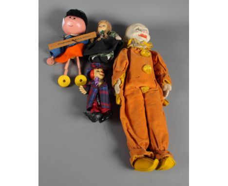 A Norah Wellings clown doll in orange suit, two other smaller dolls and a Magic Roundabout "Florence" wooden puppet