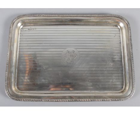 A silver dressing table tray with engine turned decoration and Greek key border, 14.5oz troy approx